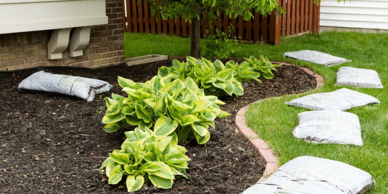 Adding mulch to garden bed