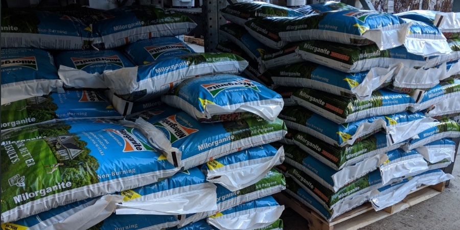 Milorganite bags on a pallet in a store.