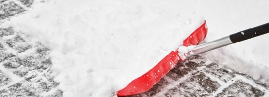 Removing snow with a shovel.