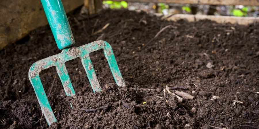 compost and shovel in a bin