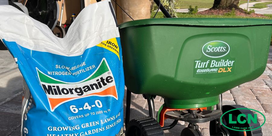 a bag of milorganite and  a spreader