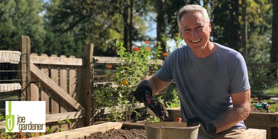 man holding soil with trowel