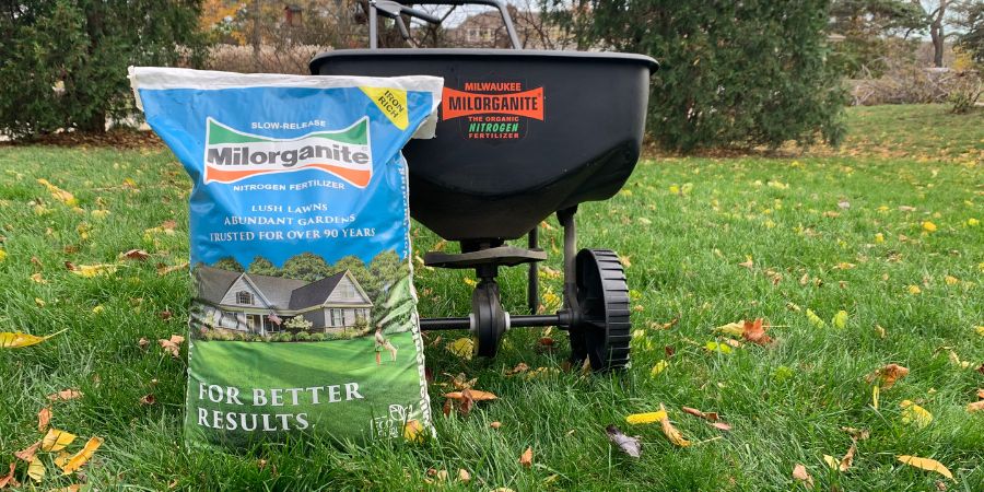 bag of milorganite and spreader