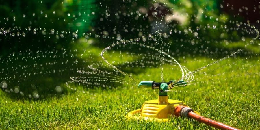 Sprinkler spraying water in lawn