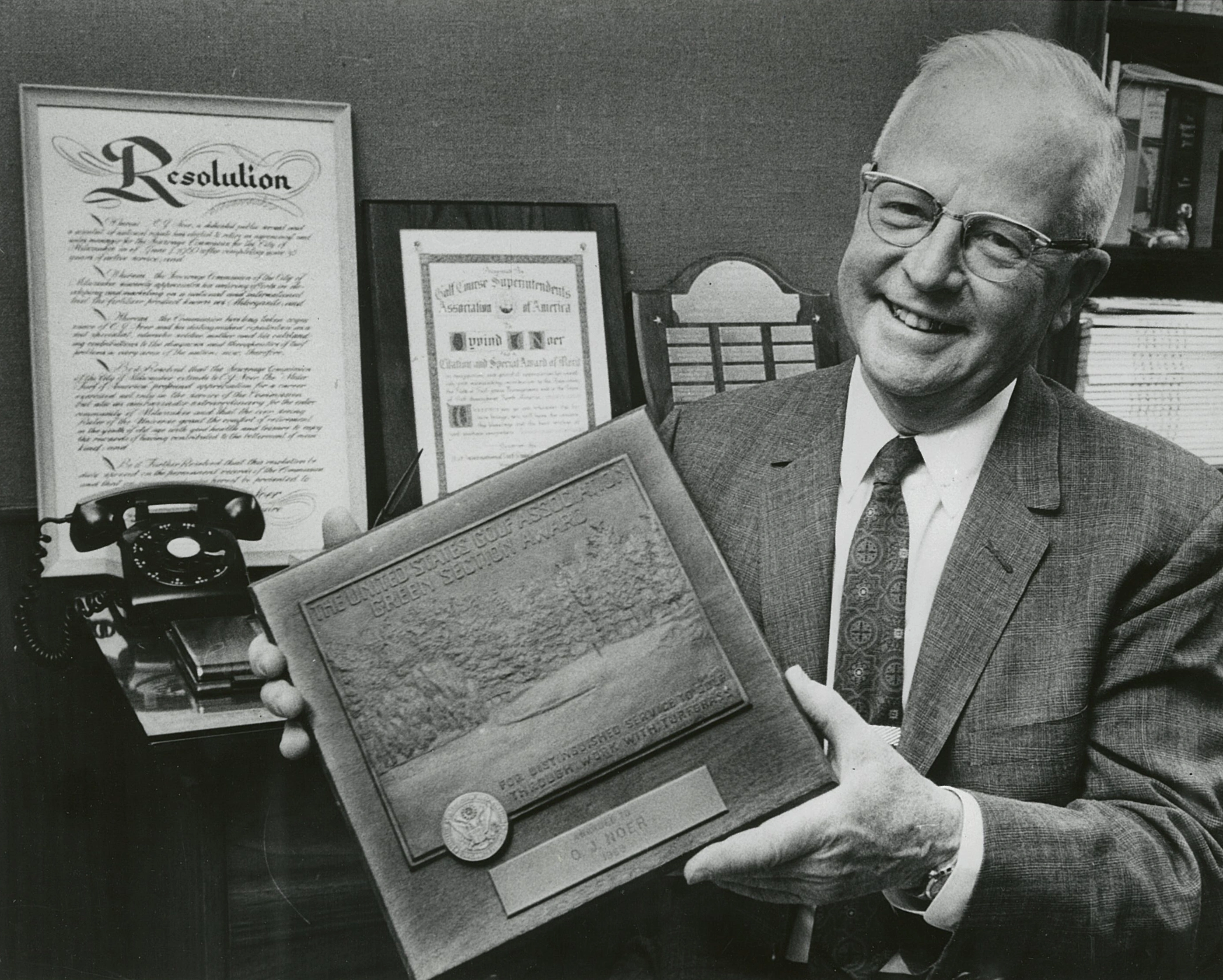 OJ Noer holding his Golf Association Award
