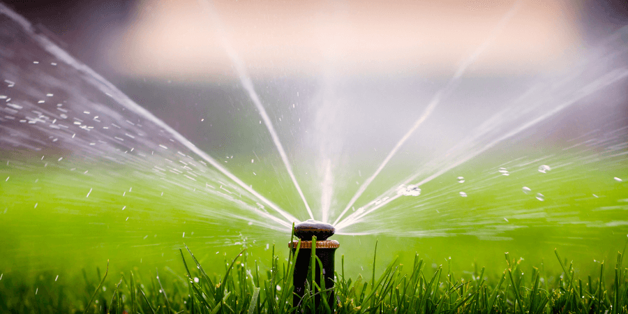 close up of a lawn sprinkler spraying water