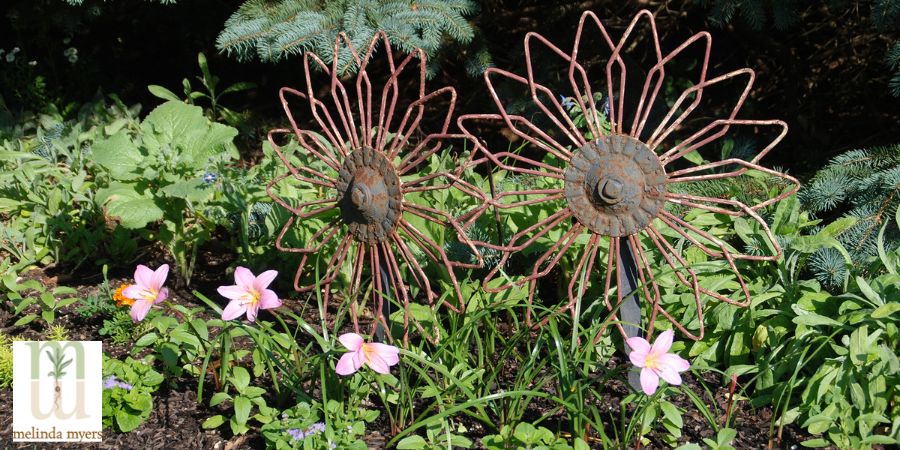 upcycled flower art in garden