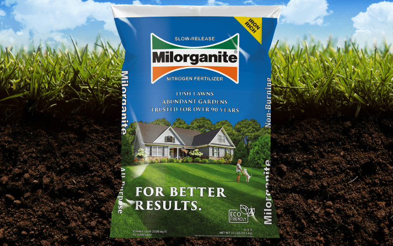 Milorganite nitrogen fertilizer bag in front of grass and dirt.png