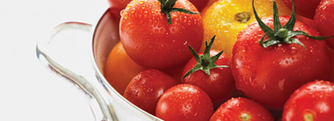 Bright red tomatoes in a bowl Bright red tomatoes like these can benefit from slow-release fertilizers like Milorganite.
